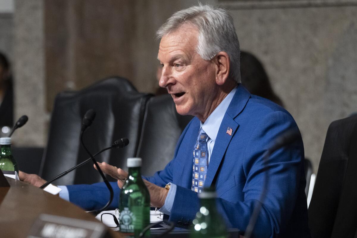 Sen. Tommy Tuberville speaks into a microphone.