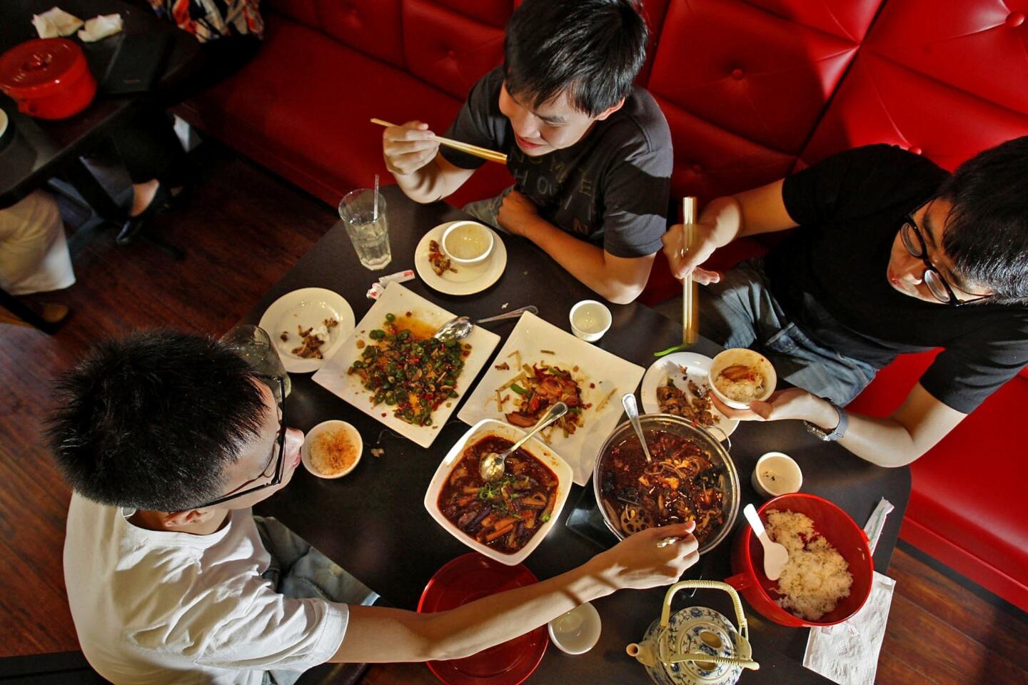 Architecture students Hao Wei, left, Pohsien Hou and Juihung Weng share dishes at lunch at Chengdu Taste in Alhambra. Chengdu Taste specializes in the Sichuan cooking of Chengdu.