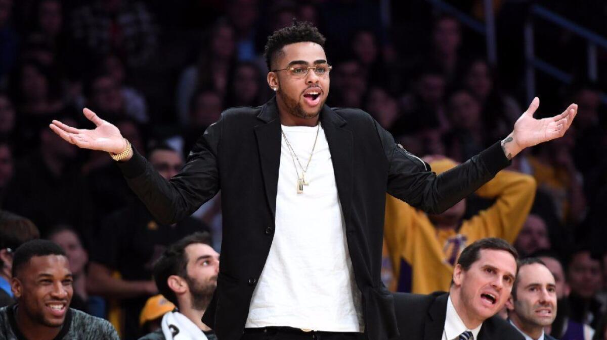 D'Angelo Russell, sidelined by a knee injury reacts to a call from a referee against the Spurs at the Staples Center on Friday.