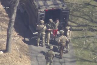 An image taken from video shows Jack Teixeira, 21, being taken into custody  in Dighton, Mass.  