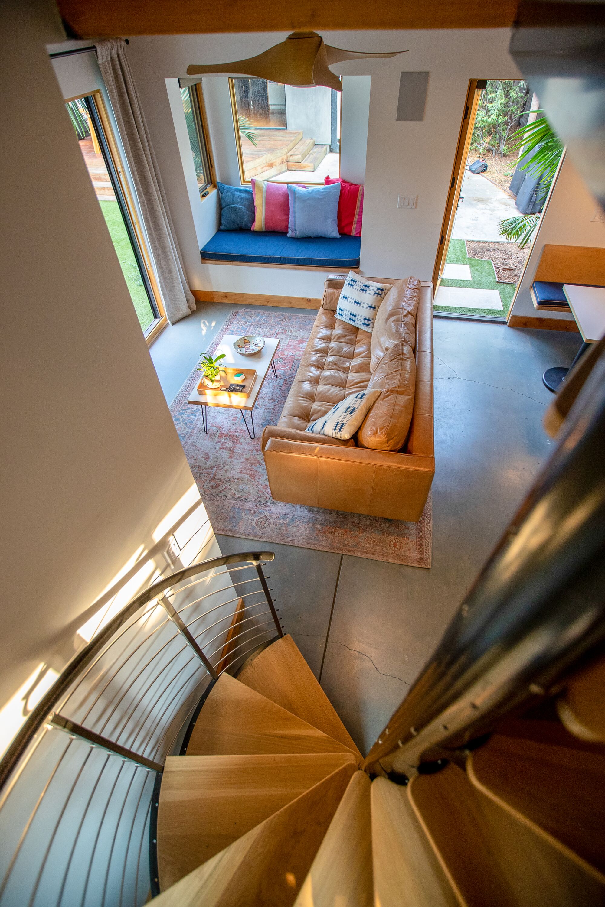 Tiny ADU in Los Angeles is a pool house, office and gym 9 A view of the spiral staircase leading to the downstairs living room and kitchen
