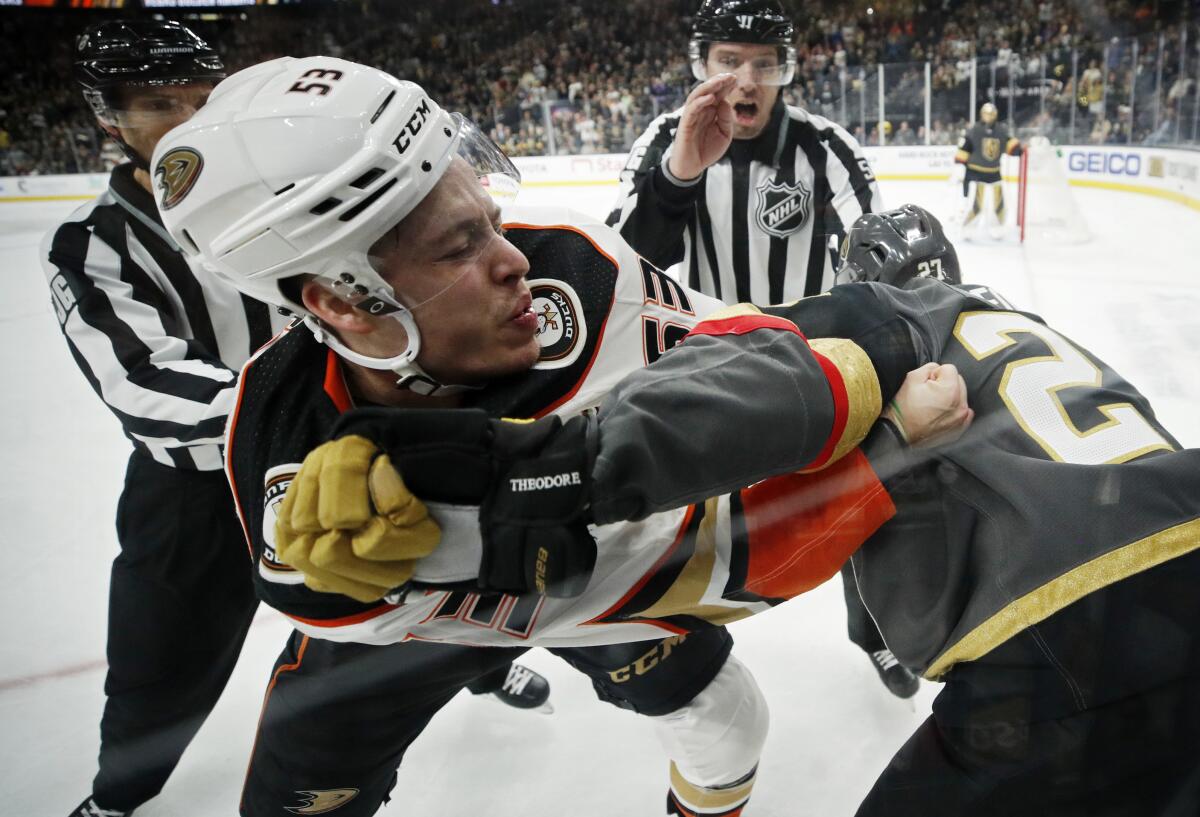 Ducks left wing Max Comtois (53) fights with Vegas Golden Knights defenseman Shea Theodore (27) during the third period of a game Dec. 31.