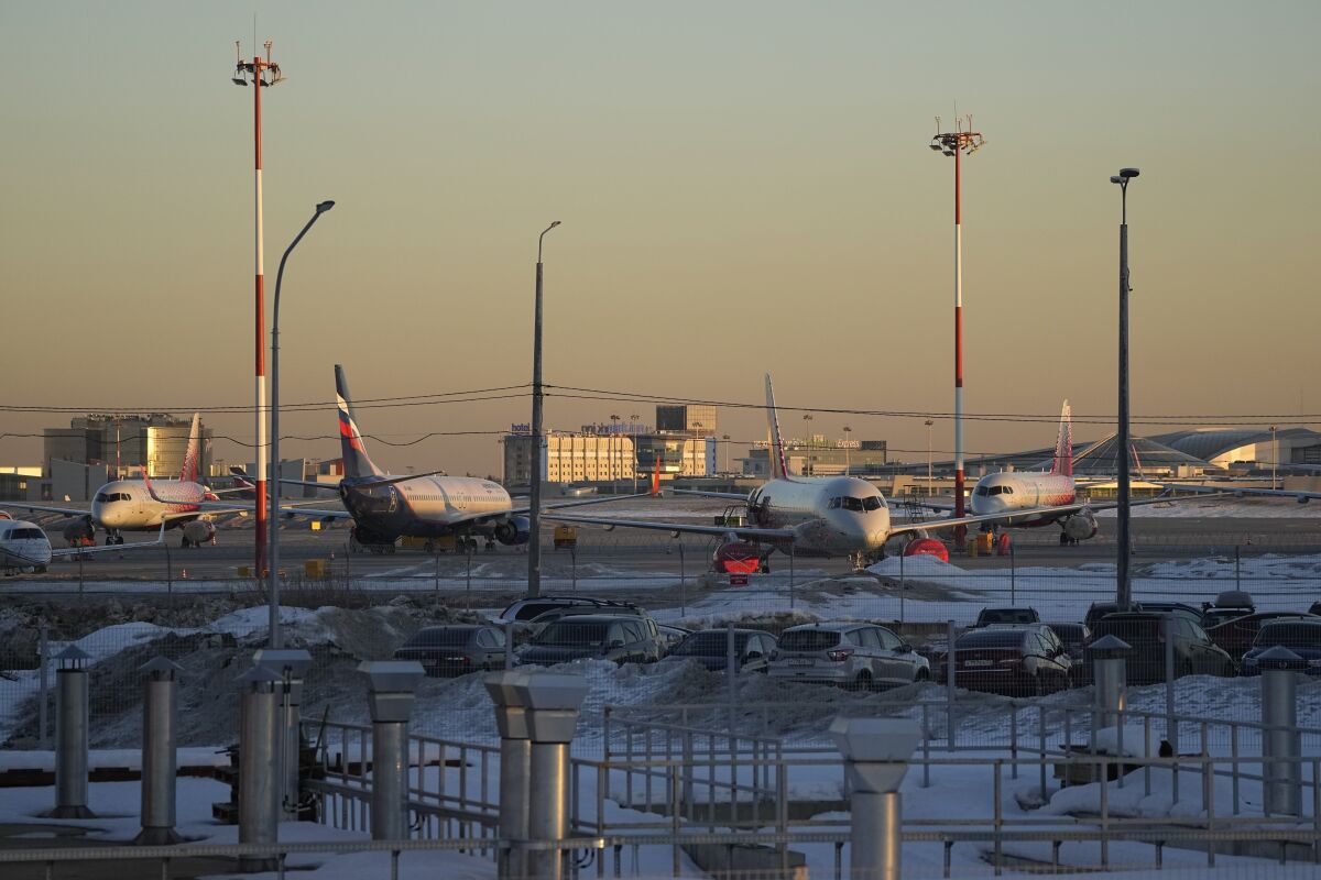 FILE - Passenger planes are parked at Sheremetyevo airport, outside Moscow, Russia, March 1, 2022. An American aircraft-leasing company with some of its planes stuck in Russia says it is making progress in getting planes back. But the chairman of Los Angeles-based Air Lease Corporation didn't give any specifics on Wednesday, March 16, 2022, such as saying how many planes the company has recovered. (AP Photo/Pavel Golovkin, File)