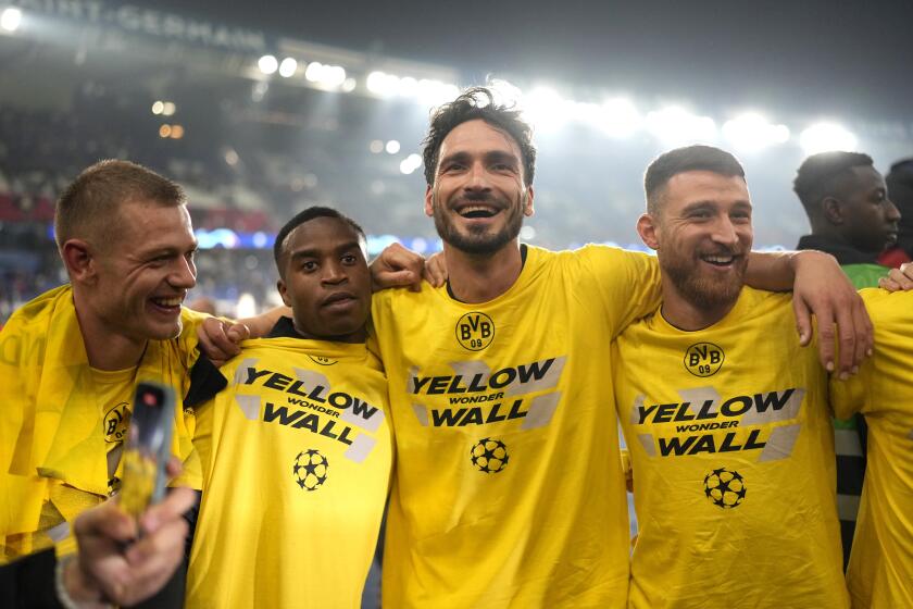 Borussia Dortmund players celebrate at the end of the Champions League semifinal second leg soccer match between Paris Saint-Germain and Borussia Dortmund at the Parc des Princes stadium in Paris, France, Tuesday, May 7, 2024. (AP Photo/Lewis Joly)