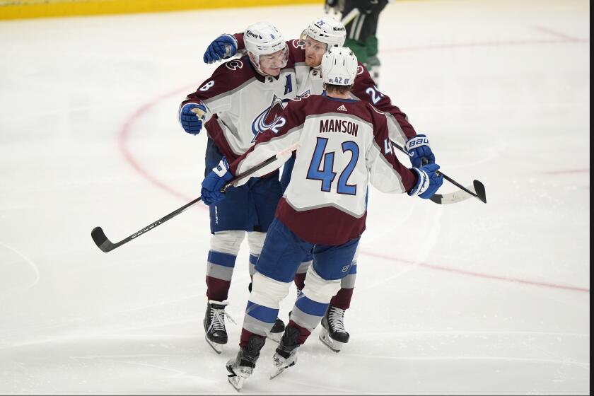 Colorado Avalanche's Josh Manson (42), Cale Makar (8) and Nathan MacKinnon (29) celebrate aftr Mackinnon scored in the third period in Game 2 of an NHL hockey Stanley Cup second-round playoff series against the Dallas Stars in Dallas, Tuesday, May 7, 2024. (AP Photo/LM Otero)