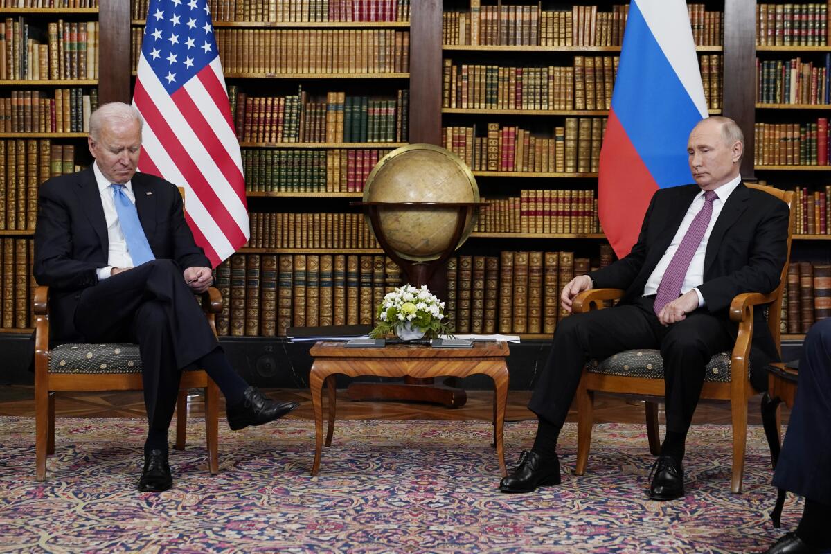 President Biden and Russian President Vladimir Putin sit before their meeting.