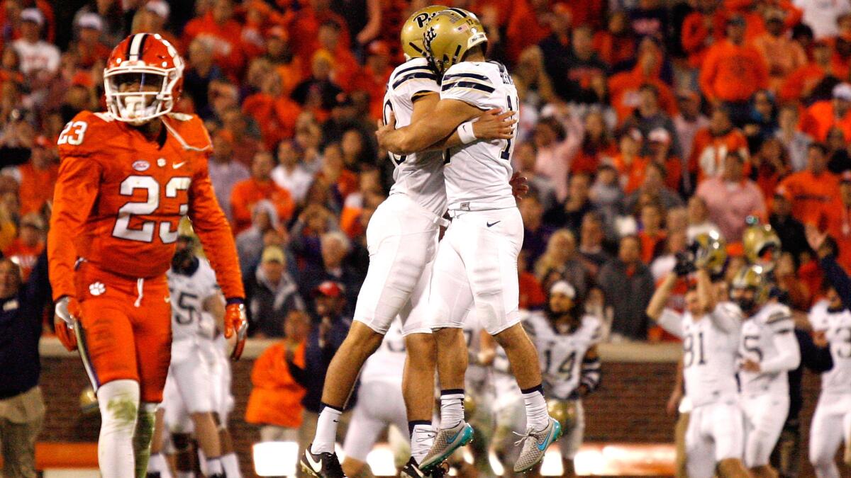 Pittsburgh kicker Chris Blewitt (12) celebrates with a teammate after kicking the game-winning field goal against the Clemson on Saturday.