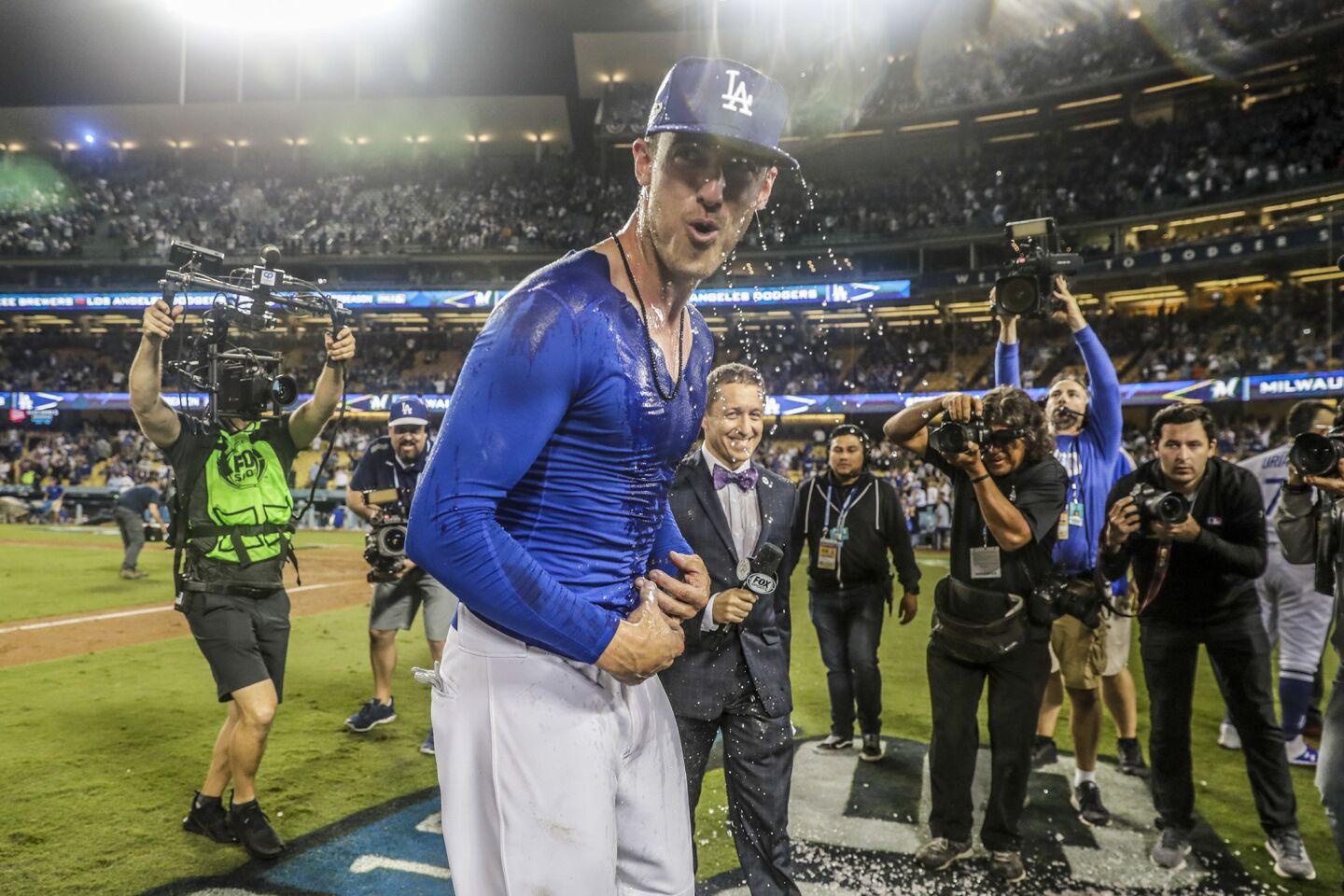 Cody Bellinger recoils after a dousing of gatorade after hitting the game winning single to beat the Brewers 2-1 in 13 innings.