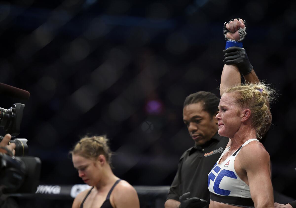 Holly Holm, right, is declared the bantamweight champion after defeating Ronda Rousey at UFC 193.