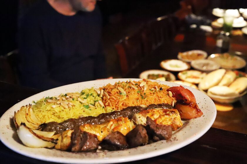 A plate of grilled Lamb skewers, chicken skewers and Kofta kebab served with traditional rice, at the Desert Moon Grill in Little Arabia in Anaheim on Tuesday, March 21, 2023. Sam Nordin the owner of the Desert Moon Grill, is taking part in Ramadan during which strict fasting is observed from sunrise to sunset. He believes fasting helps you get in touch with your body and your spiritual beliefs. (Photo by James Carbone)