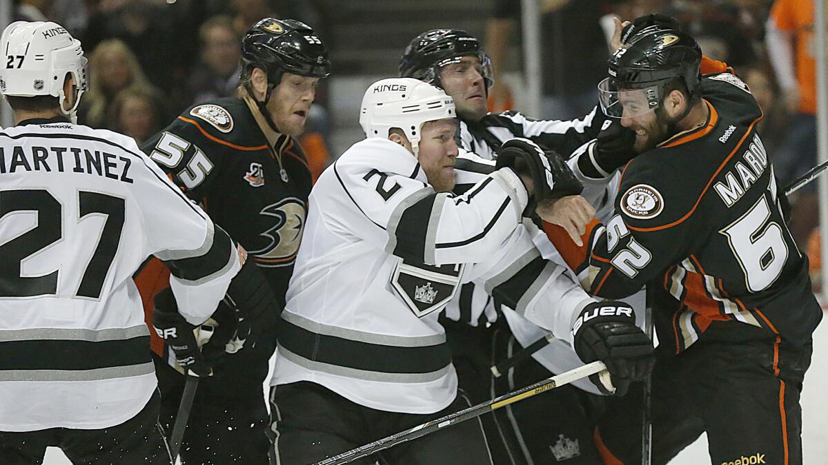 Kings defenseman Matt Greene, left, and Ducks forward Patrick Maroon shove one another in front of the Kings' net during the first period of Game 2 of the Western Conference semifinals at Honda Center.