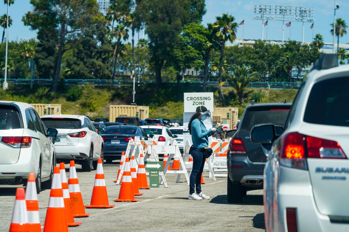 Cars at the drive-through coronavirus testing site at Dodger Stadium on Aug. 12.