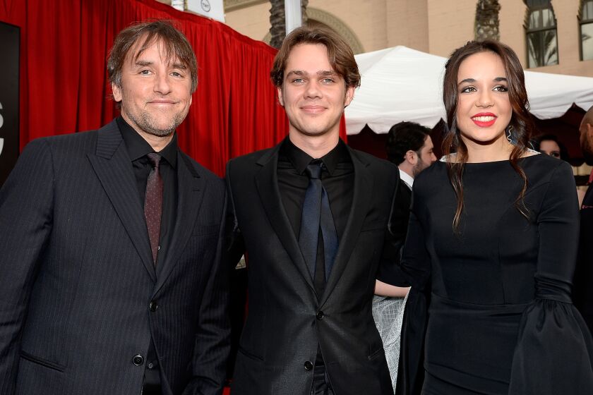 Among the guys who went with the tone-on-tone look at the SAG Awards were director Richard Linklater, left, and actor Ellar Coltrane, center, shown with "Boyhood" costar Lorelei Linklater.