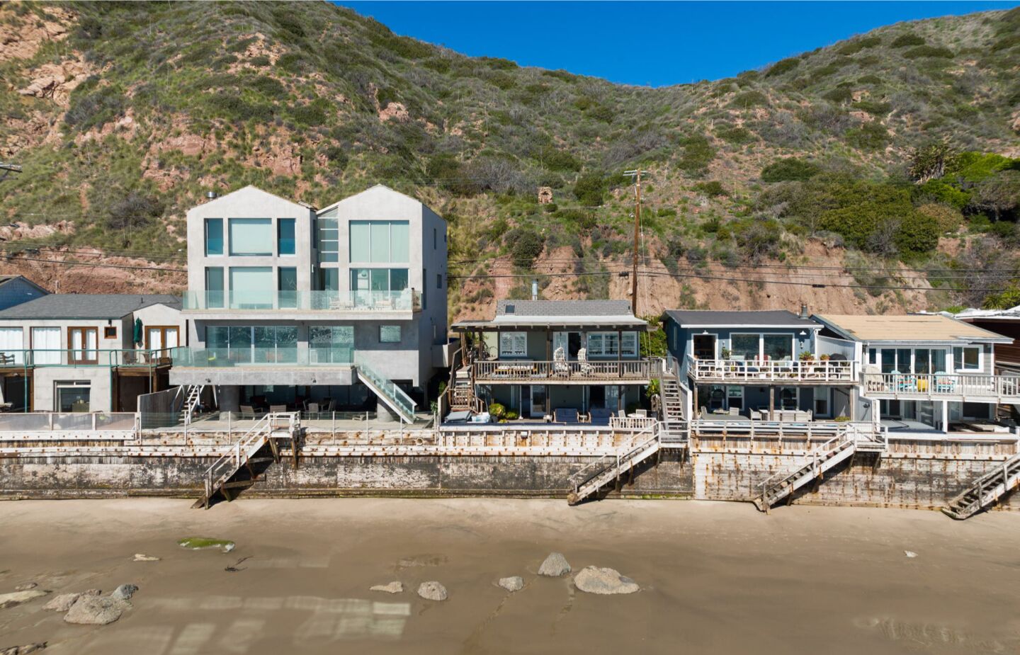 The cozy cottage spans 1,250 square feet and descends to 42 feet of frontage on Las Flores Beach.