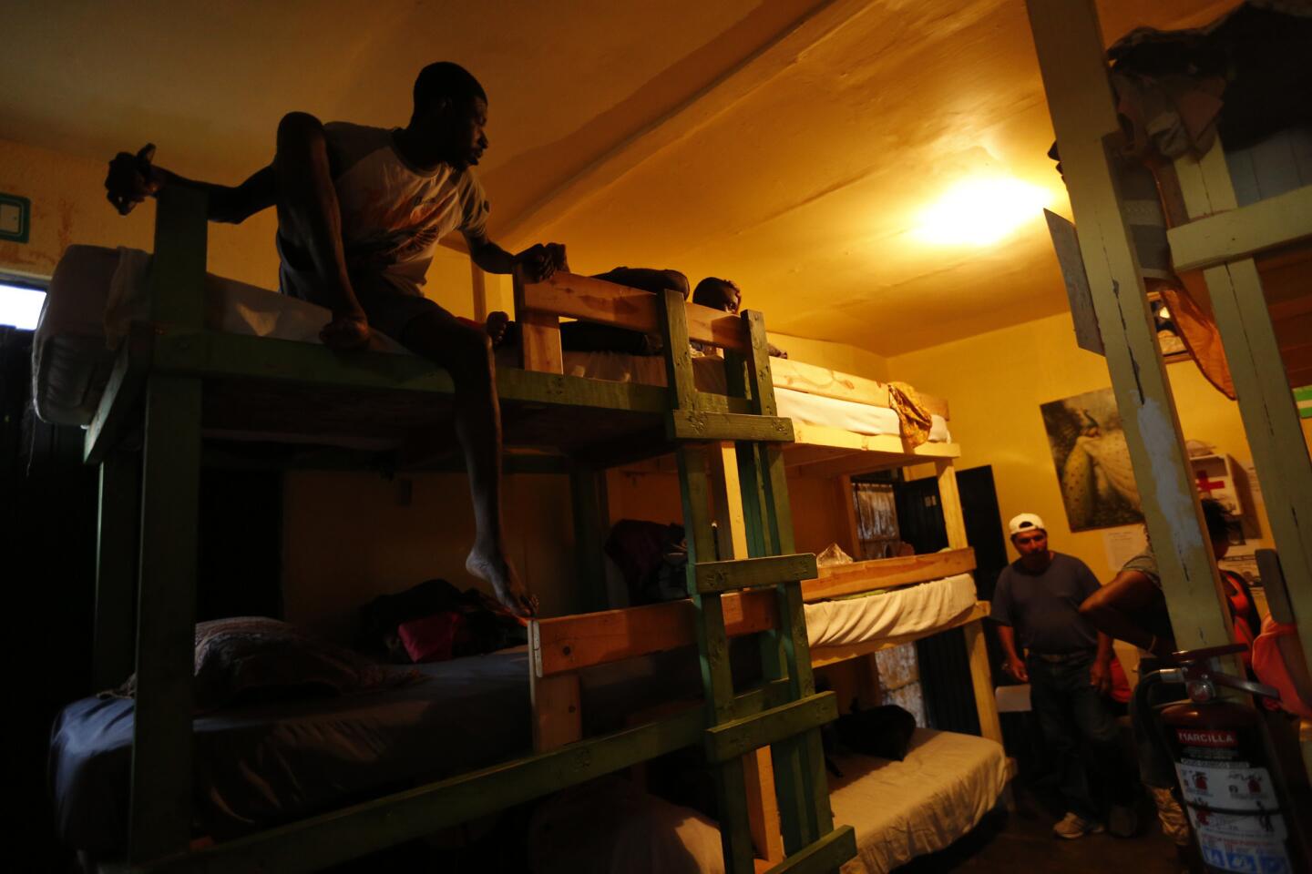 Haitian and African migrants sleep on bunks at a shelter operated by Movimiento Juventud 2000 in Tijuana, Mexico.