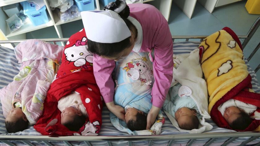 A nurse cars for newborn babies at a hospital in Xiangyang city in central China.