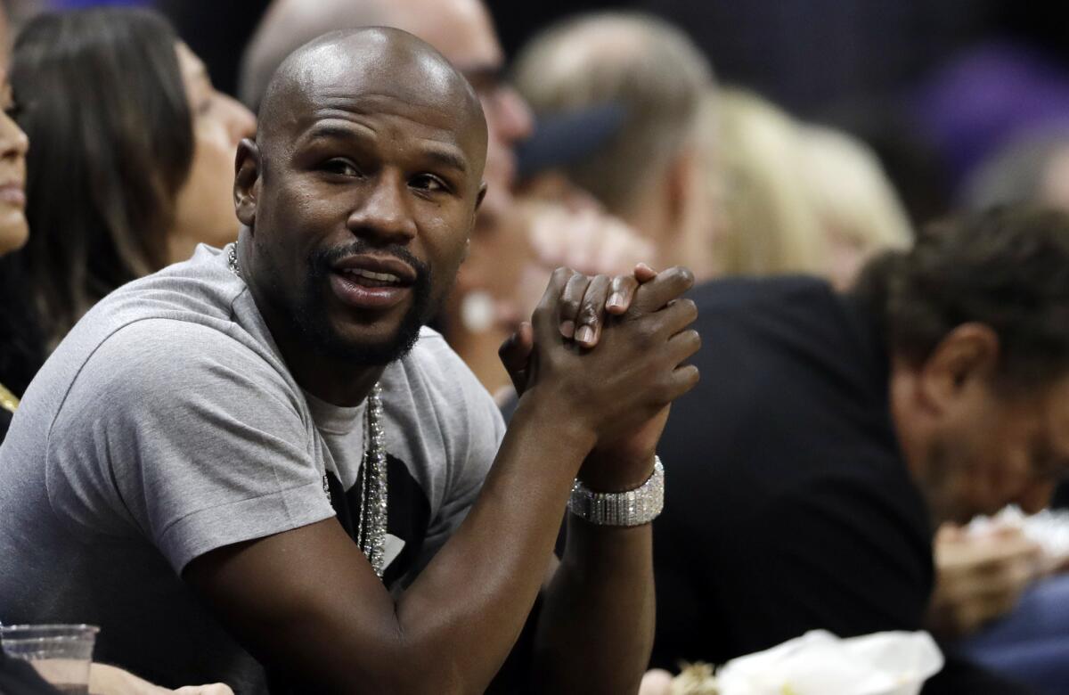 Boxer Floyd Mayweather watches an NBA basketball game between the Los Angeles Clippers and the Denver Nuggets Wednesday, Oct. 17, 2018, in Los Angeles.