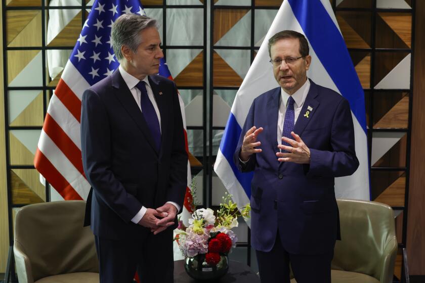 U.S. Secretary of State Antony Blinken, left, and Israeli President Isaac Herzog talk during their meeting in Tel Aviv, Israel, Wednesday, May 1, 2024. (Evelyn Hockstein/Pool Photo via AP)