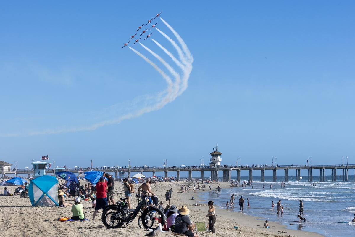 Power of Canada Snowbird's army flies in the form of Huntington Beach Pier on Friday.