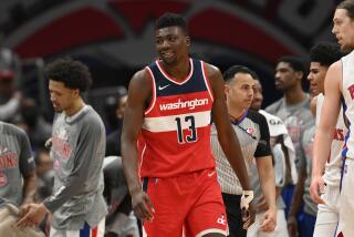 Washington Wizards center Thomas Bryant (13) reacts during the second half of an NBA basketball game against the Detroit Pistons, Tuesday, March 1, 2022, in Washington. The Wizards won 116-113. (AP Photo/Nick Wass)