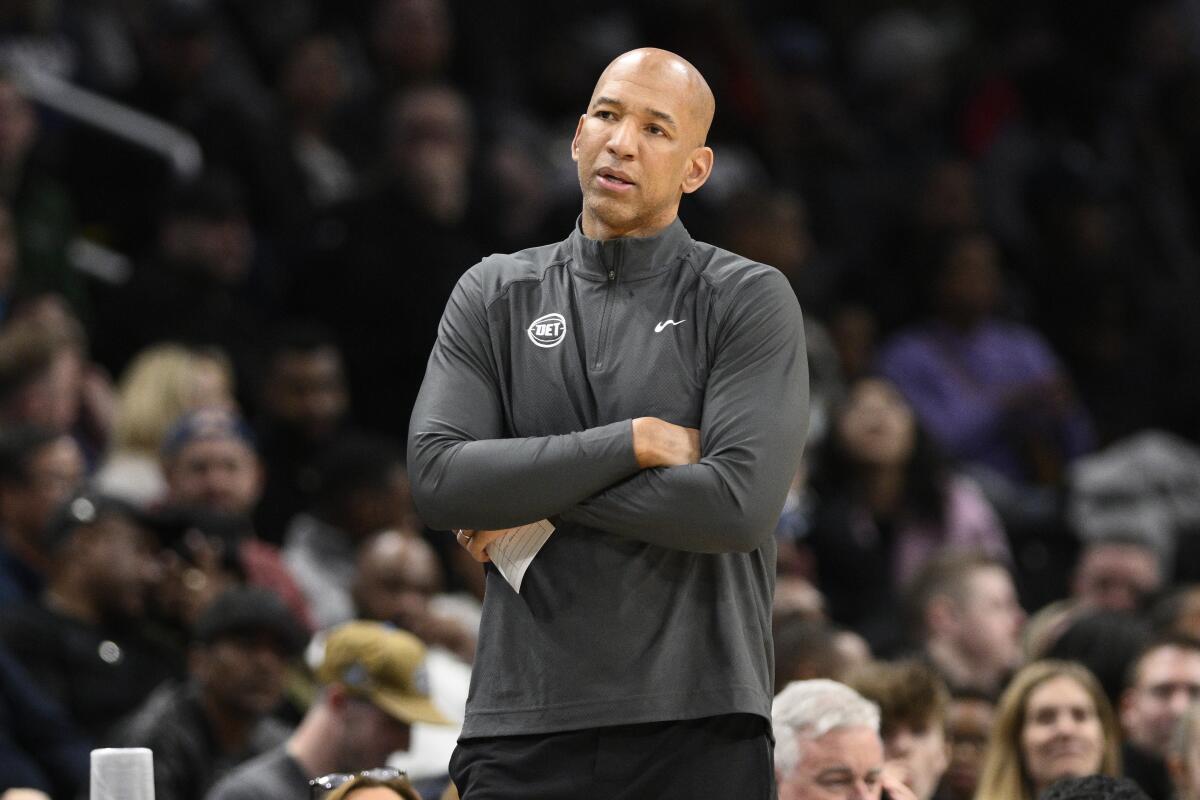 Pistons coach Monty Williams crosses his arms and looks on from the sideline during a game