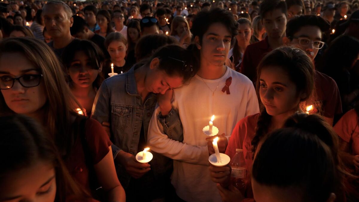 Thousands gather for an evening vigil at Pine Trails Park in Parkland, Florida to remember those killed and injured in the Marjory Stoneman Douglas High School shooting