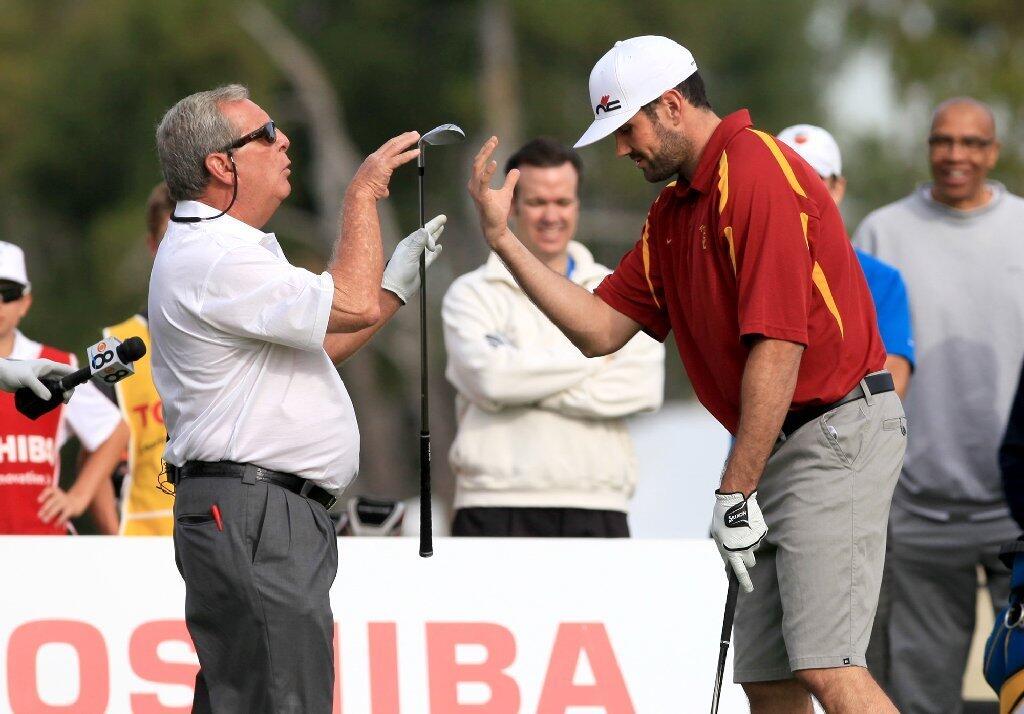 Team USC's Fuzzy Zoeller, left, jokes around with teammate and Heisman Trophy winner Matt Leinart during the second annual Toshiba Classic Skills Challenge at Newport Beach Country Club on Tuesday.
