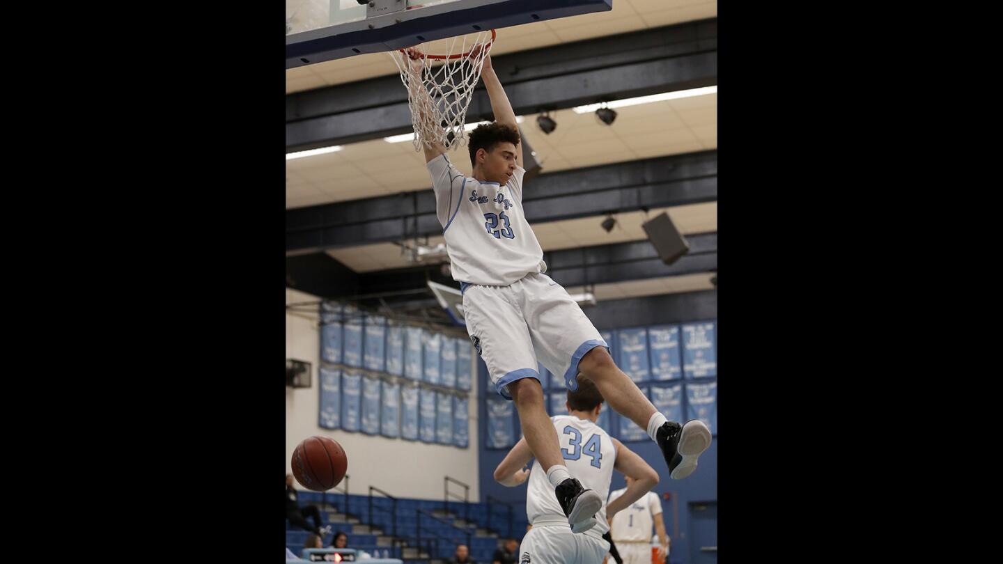 Corona del Mar High’s Kevin Kobrine dunks the ball during the first half against Leuzinger in the Corona del Mar Beach Bash tournament on Wednesday.