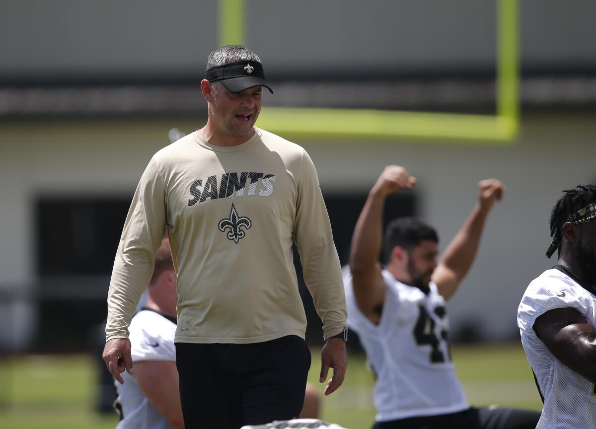 New Orleans Saints quarterbacks coach Joe Lombardi walks through their NFL football practice in the summer.