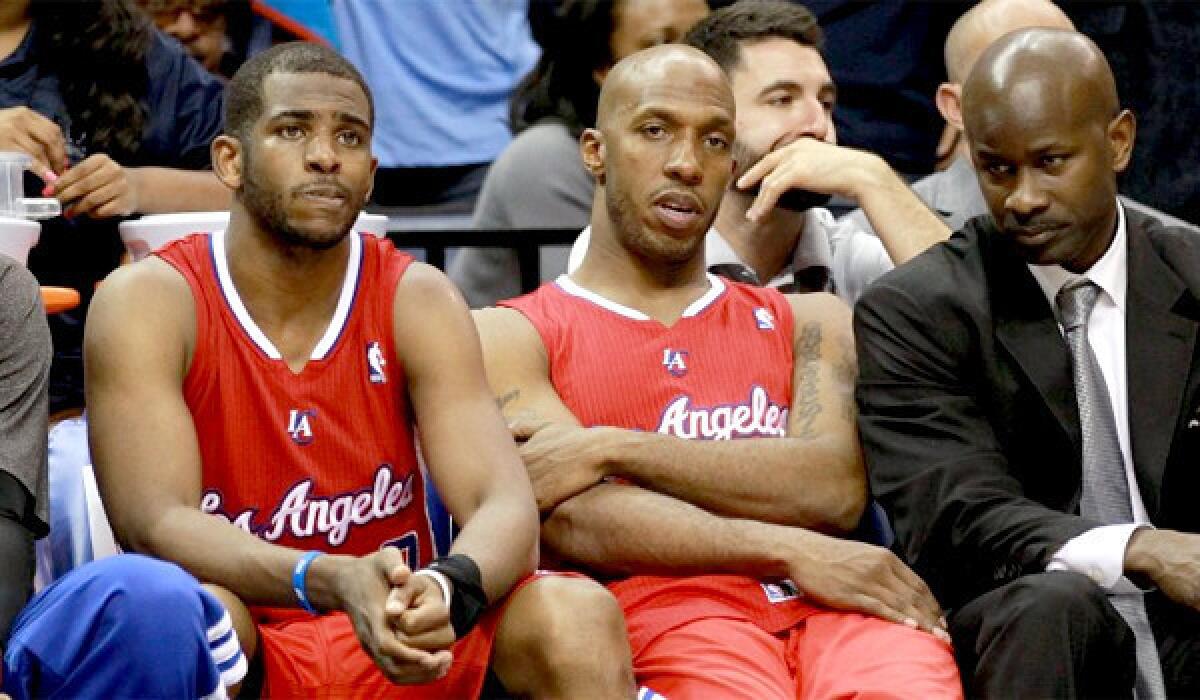 Chris Paul and Chauncey Billups look on from the Clippers' bench as L.A. was routed in a loss to the Grizzlies in Memphis, 104-83.