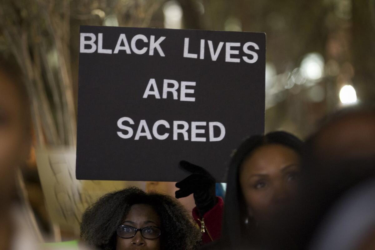 People gather outside the Tarrant County Courthouse in Texas last month to protest a white police officer wrestling Jacqueline Craig, a black woman, to the ground. The incident was captured on video.