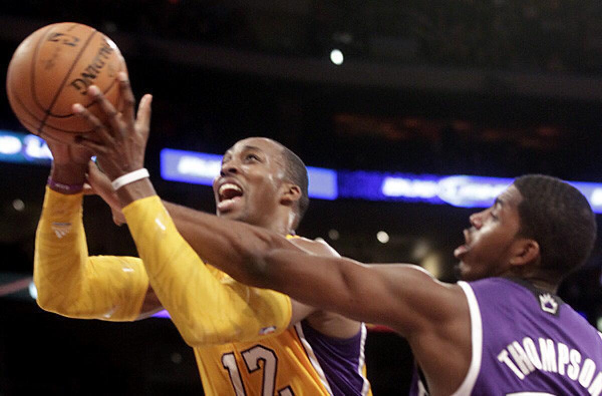 Lakers center Dwight Howard is fouled by Kings power forward Jason Thompson.