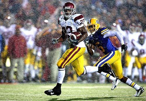 Chauncey Washington scored on a 36-yard run in the second quarter against California on Saturday. The Trojans won 24-17 before a rain-soaked, sold-out crowd of 72,516 at Berkeley.