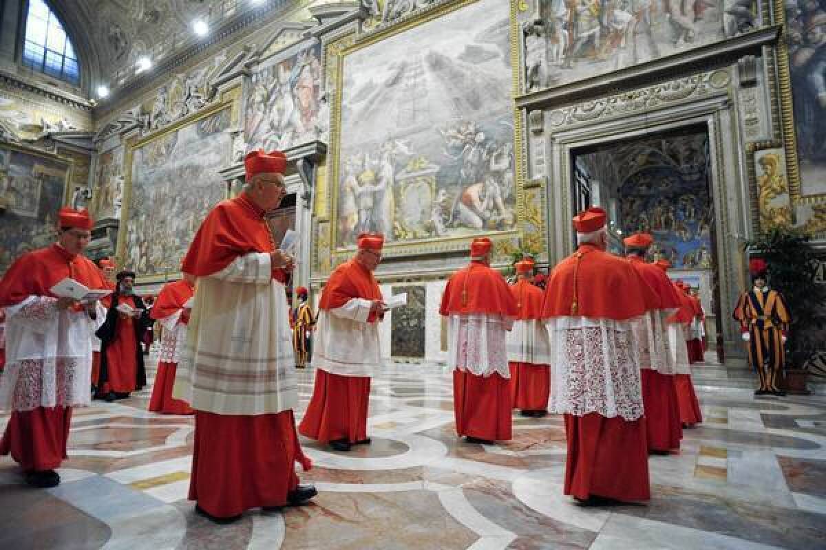 Cardinals enter the Sistine Chapel before the conclave begins.