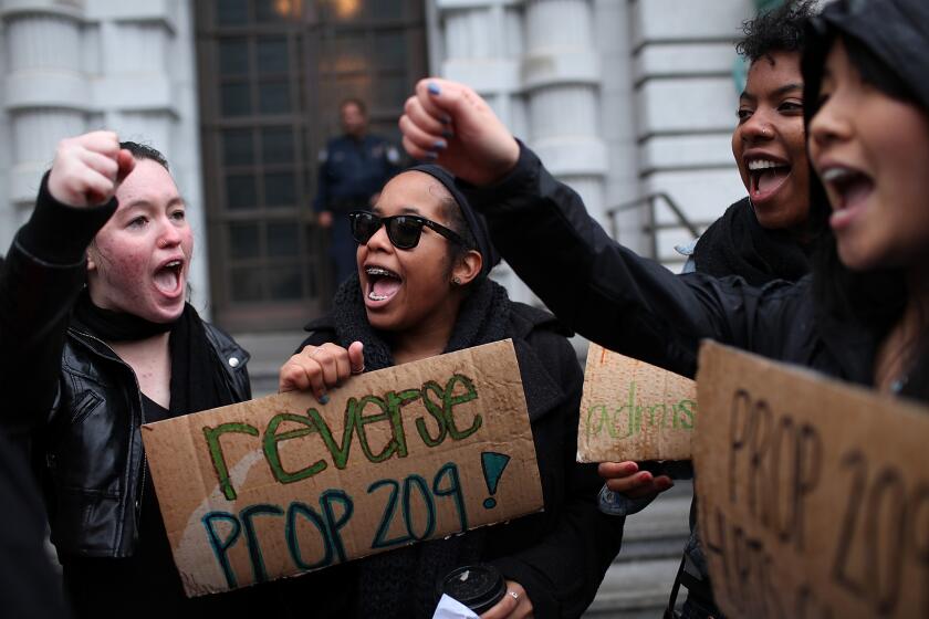SAN FRANCISCO, CA - FEBRUARY 13: Students hoping for a repeal of California's Proposition 209 hold signs as they protest outside of the Ninth U.S. Circuit Court of Appeals on February 13, 2012 in San Francisco, California. A Federal appeals court will hear arguments in a lawsuit that wants to overturn Proposition 209, a voter approved measure that prohibits affirmative action at state universities. (Photo by Justin Sullivan/Getty Images)