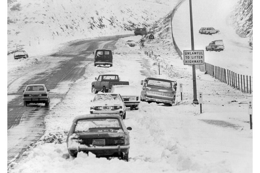 Feb. 3, 1983: After a winter storm, cars without chains sit abandoned along Highway 14 seven miles south of Palmdale.