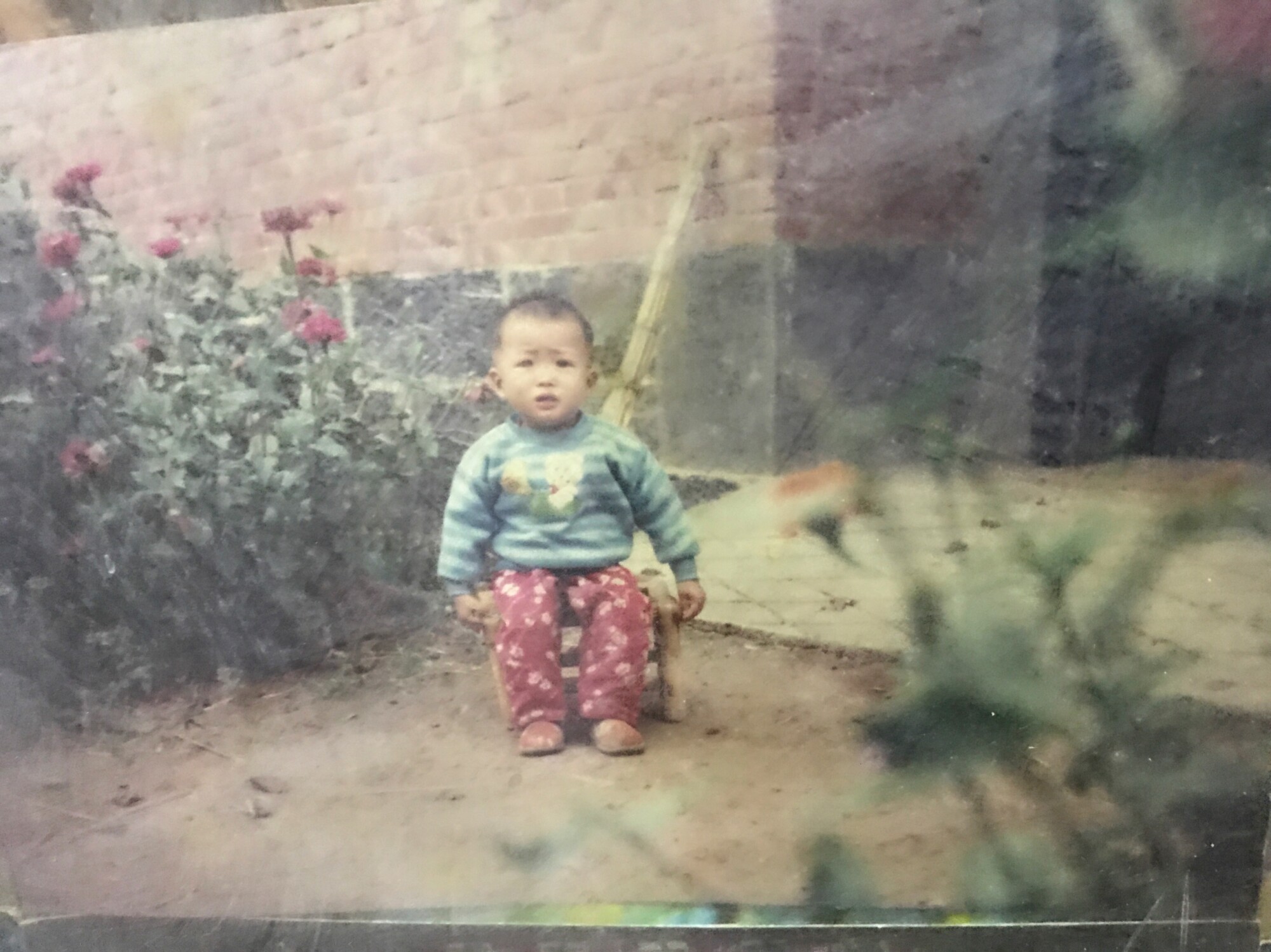 An old photo of a baby outside 