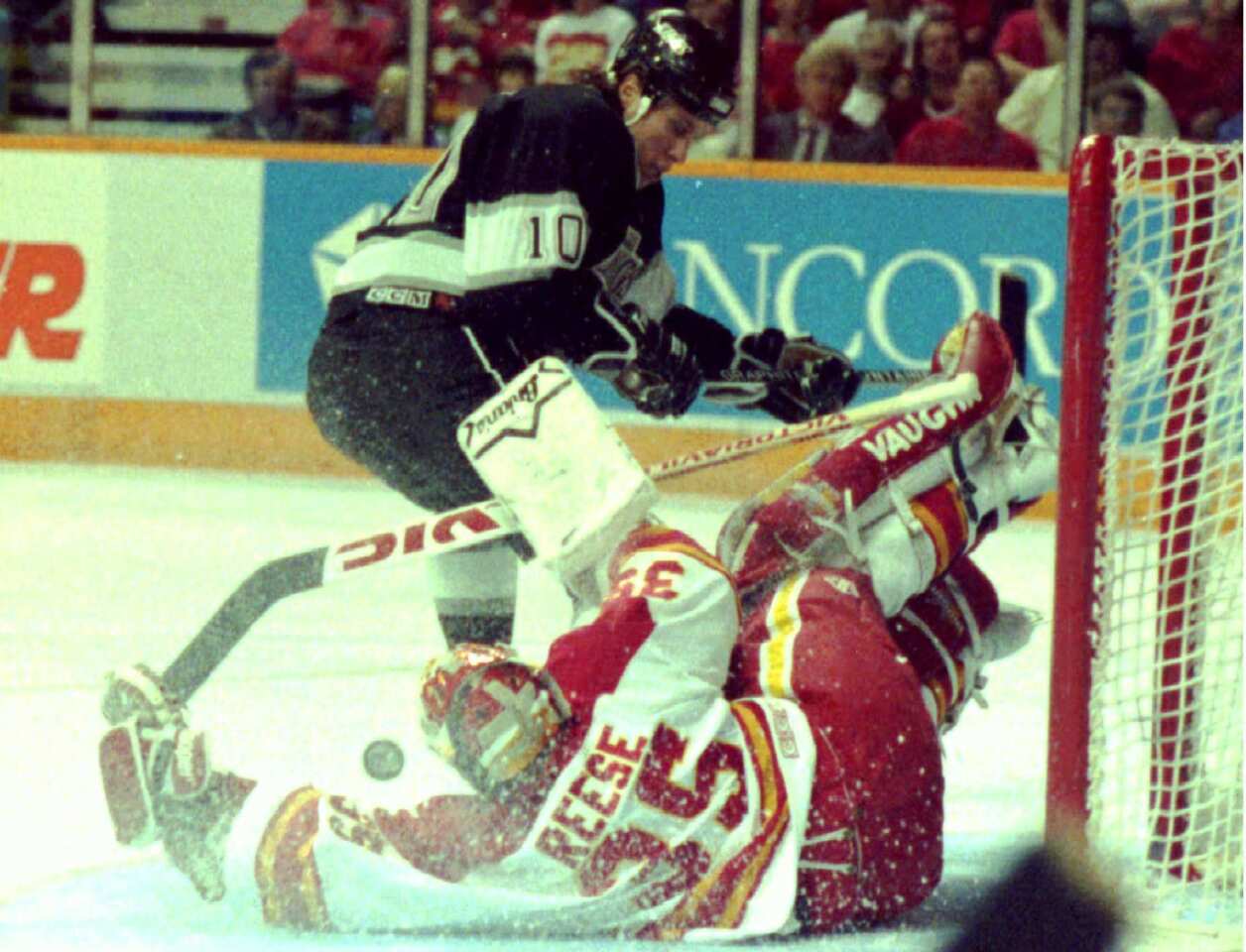 Calgary goalie Jeff Reese makes a save on a shot by Kings left wing Warren Rychel during the Kings' 9-4 victory in Game 5 of the Smythe Division semifinals. The Kings, which finished third behind Vancouver and Calgary in the division during the regular season, defeated the Flames in six games.