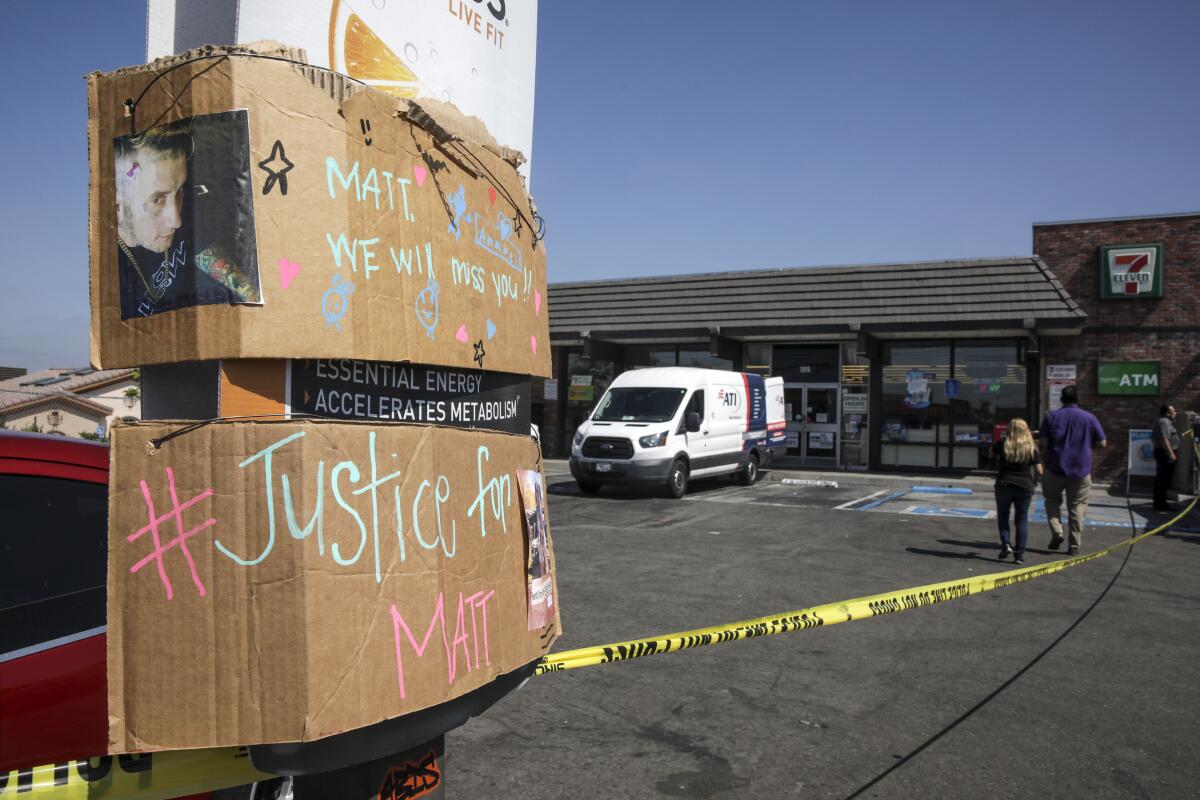 Cardboard signs reading "Matt, we will miss you" and "Justice for Matt" 