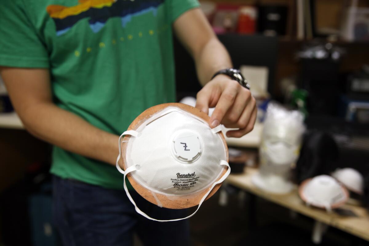 Albert Nazeeri holds an N95 respirator