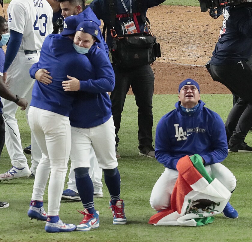 Victor Gonzalez tearfully clutches the Mexican flag after the Dodgers clinched the 2020 World Series.