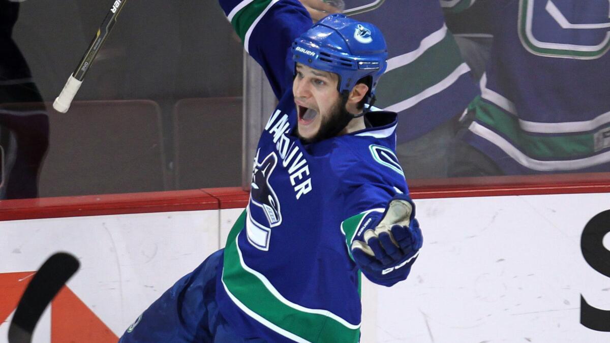 Vancouver Canucks defenseman Kevin Bieksa celebrates a playoff goal against the San Jose Sharks in 2011. Bieksa signed a two-year deal with the Ducks on Thursday.