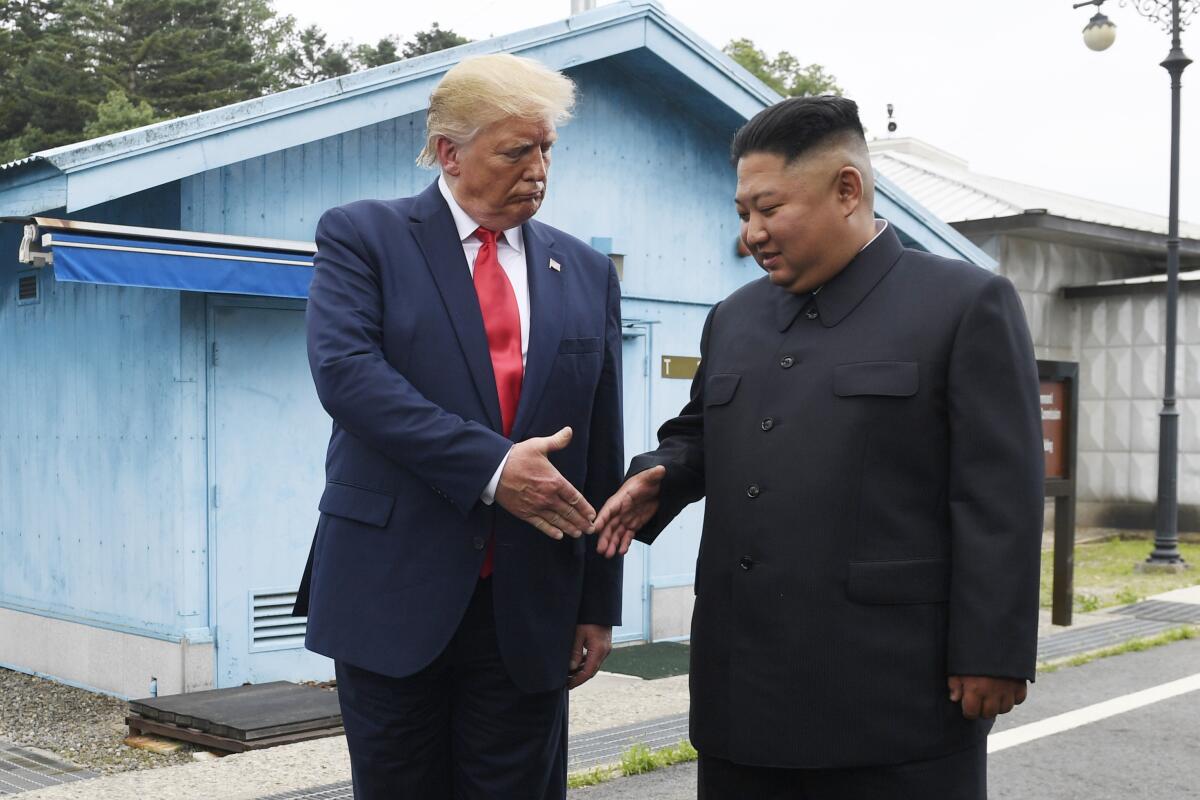 Then-President Trump shakes hands with North Korean leader Kim Jong Un in a demilitarized zone of South Korea in 2019. 