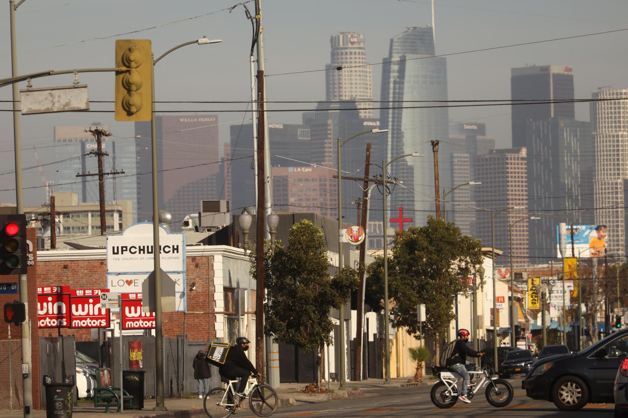 Bicyclists cross the street. 