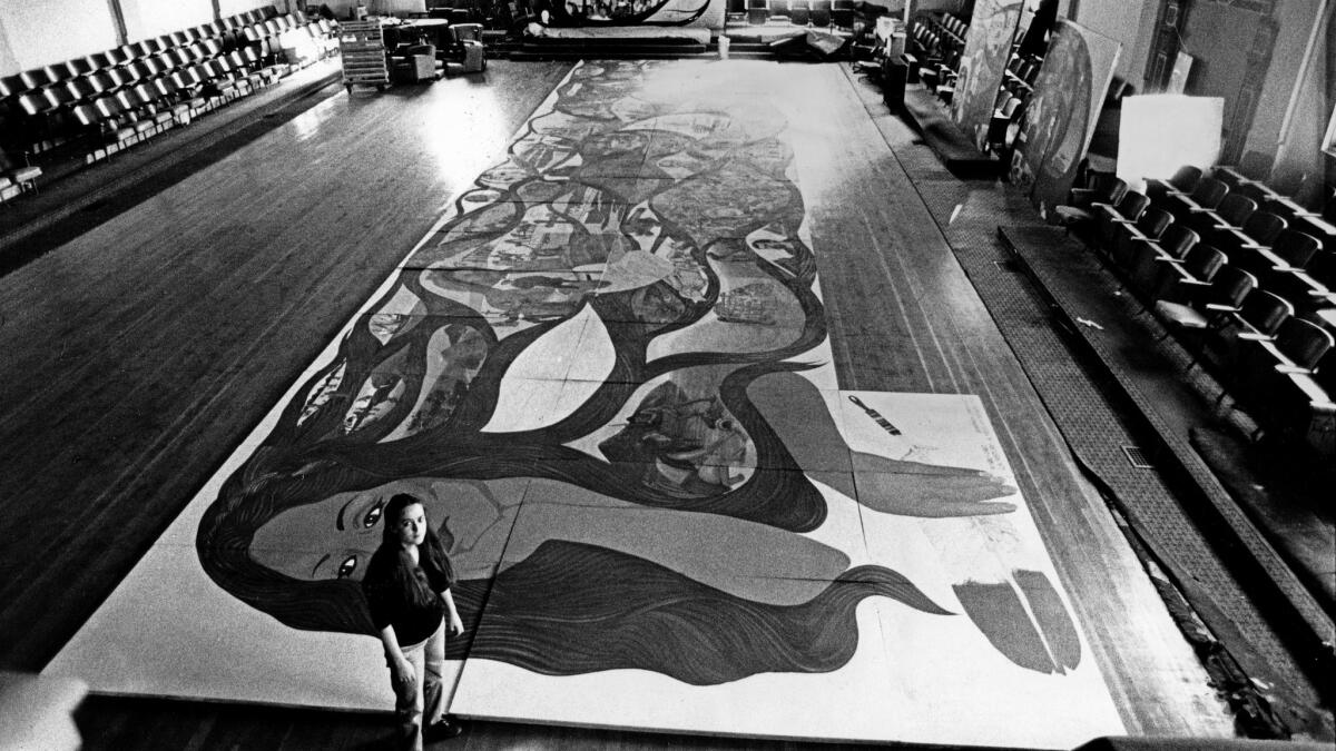Barbara Carrasco stands before her portable mural in 1983.