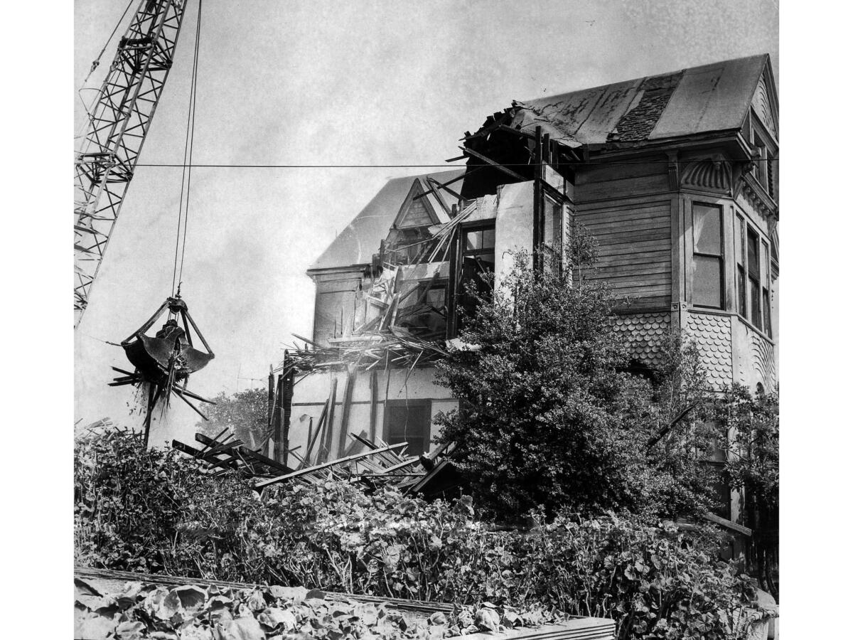 Sep. 10, 1966: A demolition crane takes a bite out of a Victorian home on Bunker Hill. The Castle and Salt Box were saved from demolition.