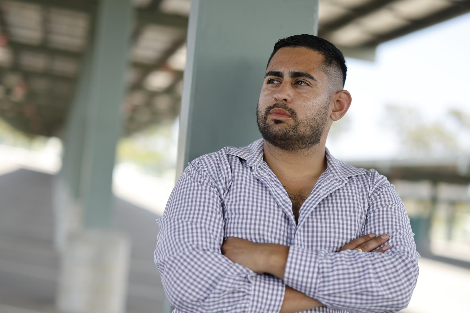 Brian Gavidia stands in a parking lot