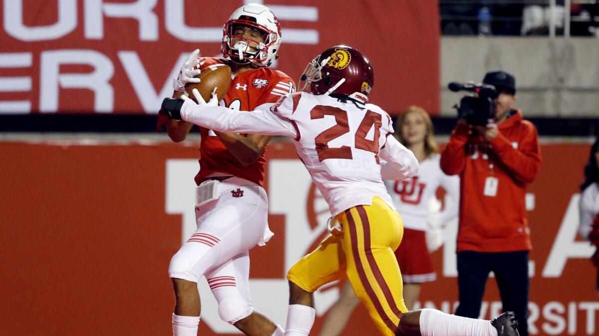 Utah wide receiver Solomon Enis, left, catches a touchdown as USC cornerback Isaiah Langley (24) defends during the second half on Saturday in Salt Lake City.