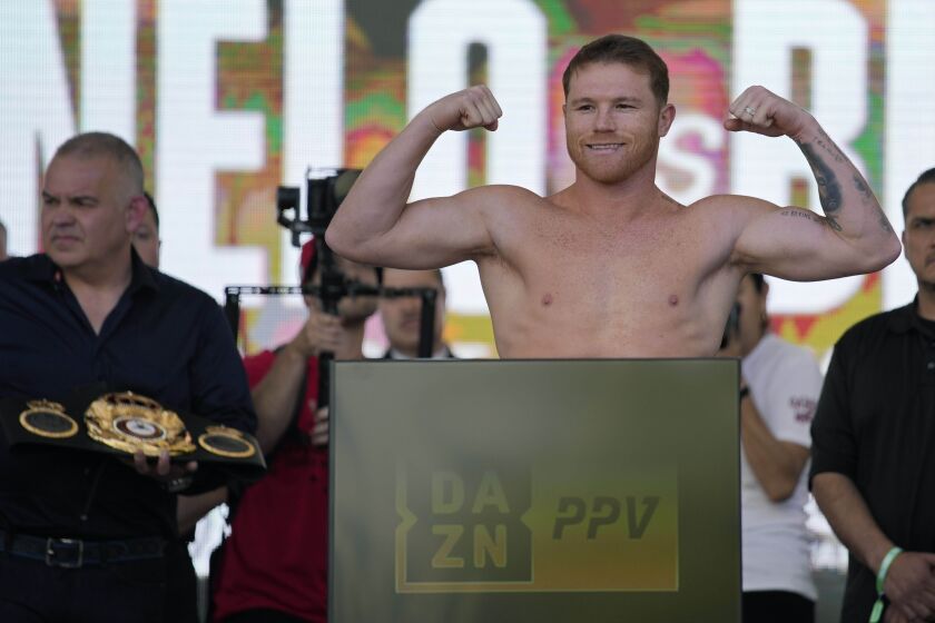 Canelo Alvarez poses during a ceremonial boxing weigh-in, Friday, May 6, 2022, in Las Vegas. Alvarez is scheduled to fight Dmitry Bivol Saturday in Las Vegas. (AP Photo/John Locher)
