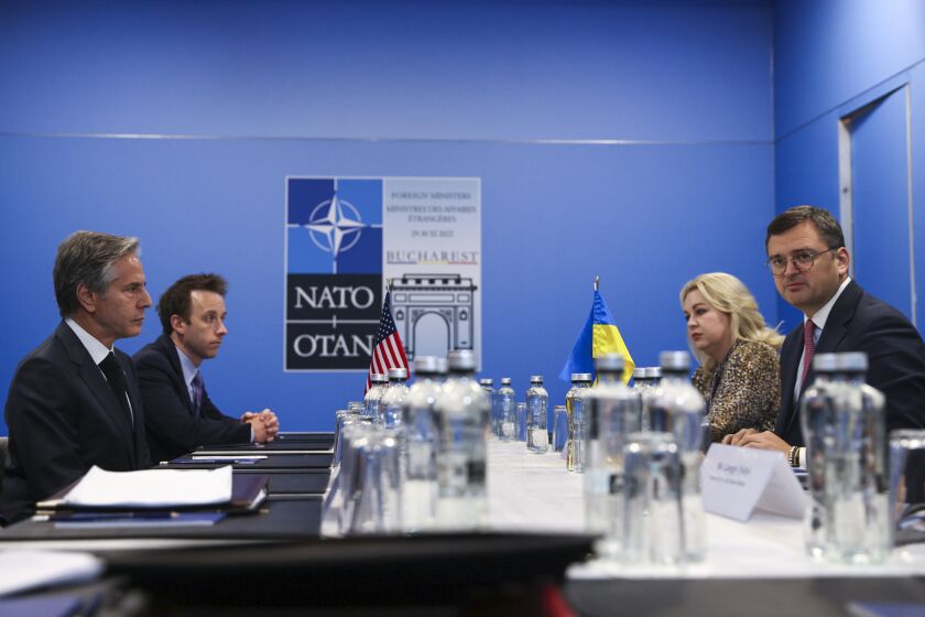 U.S. Secretary of State Antony Blinken meets with Ukraine's Foreign Minister Dmytro Kuleba during the NATO foreign ministers meeting in Bucharest, Romania, Wednesday, Nov. 30, 2022. (Stoyan Nenov/Pool Photo via AP)